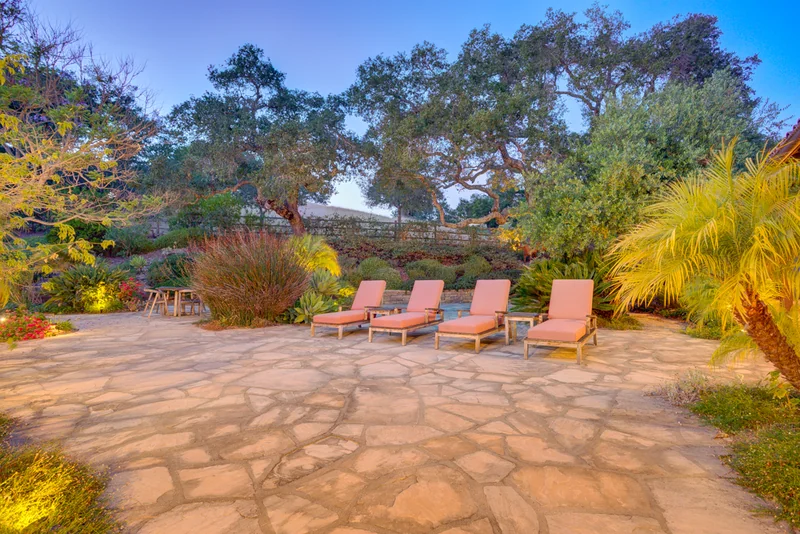 Garden seating terrace with warm landscape lighting.