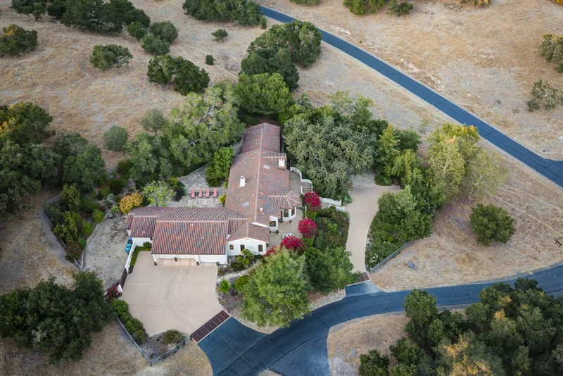 Overhead view of a red-roofed estate and surrounding grounds.